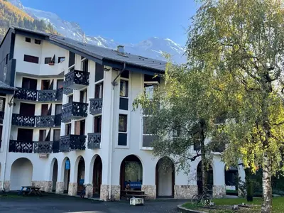 a white building with a balcony on the side of it at Apartment Le Triolet-8 by Interhome in Chamonix-Mont-Blanc