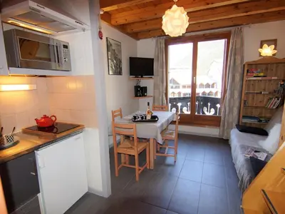 a dining room with a table and chairs and a tv at Apartment Le Triolet-8 by Interhome in Chamonix-Mont-Blanc