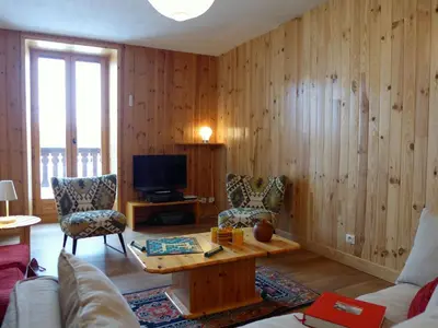 a living room with a couch and a table and a tv at Apartment Chalet Le Tour by Interhome in Chamonix-Mont-Blanc