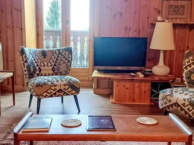 a living room with a couch and a tv at Apartment Chalet Le Tour by Interhome in Chamonix-Mont-Blanc