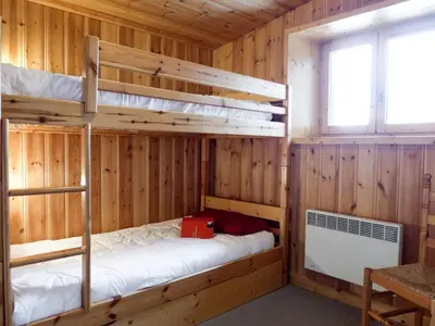 two bunk beds in a wooden room with a window at Apartment Chalet Le Tour by Interhome in Chamonix-Mont-Blanc