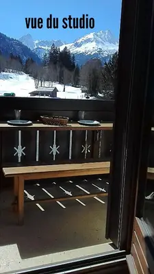 a wooden bench on a balcony with a view of a mountain at cimes d'or in Les Contamines-Montjoie