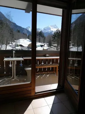 a room with a window with a view of a snowy mountain at cimes d'or in Les Contamines-Montjoie