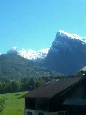 a mountain with snow capped mountains in the background at Ferme Dowena in Morillon