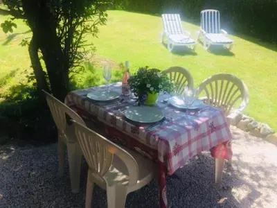 a table with four chairs and a table with a table cloth at Ferme Dowena in Morillon