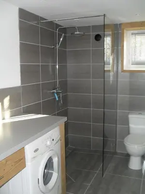 a bathroom with a shower and a washing machine at Les Clarines in Saint-Gervais-les-Bains