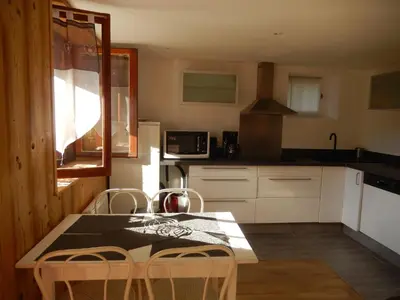 a kitchen with a table and chairs in it at Les Clarines in Saint-Gervais-les-Bains