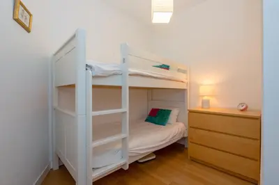 a white bunk bed in a room with a desk at Summit Apartment - Chamonix in Chamonix-Mont-Blanc