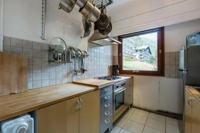 a small kitchen with a stove and a window at Summit Apartment - Chamonix in Chamonix-Mont-Blanc