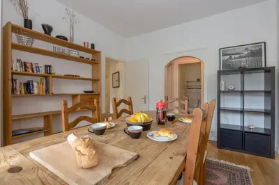 a dining room with a wooden table with food on it at Summit Apartment - Chamonix in Chamonix-Mont-Blanc
