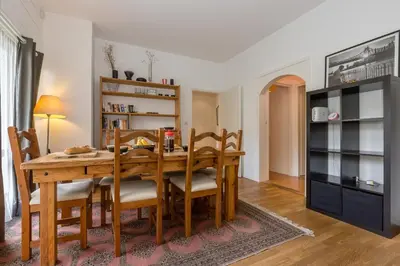 a dining room with a wooden table and chairs at Summit Apartment - Chamonix in Chamonix-Mont-Blanc