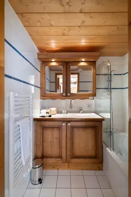 a bathroom with a sink and a shower and a mirror at Résidence Pierre & Vacances Premium Les Fermes Du Soleil in Les Carroz d'Araches