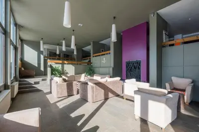 a living room with a purple couch and a table at Résidence Pierre & Vacances La Forêt in Flaine