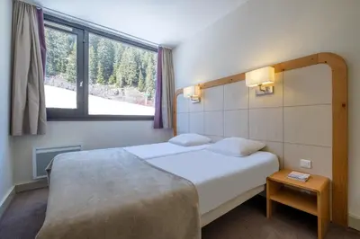 a lobby with a foosball table in the middle of a room at Résidence Pierre & Vacances La Forêt in Flaine