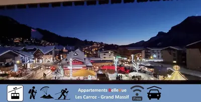 a town lit up at night with christmas lights at BelleVue centre, wifi, mountain view in Les Carroz d'Araches
