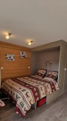 a bedroom with a large bed in a room at BelleVue centre, wifi, mountain view in Les Carroz d'Araches