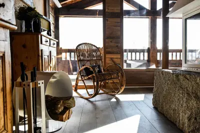 a room with two chairs and a table and windows at Chalets Grands Montets in Chamonix-Mont-Blanc
