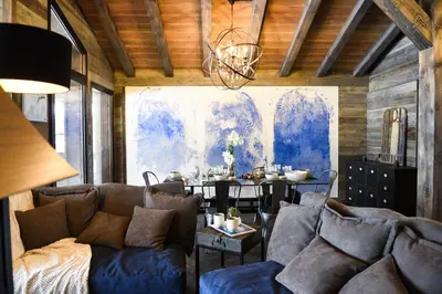 a living room with a couch and a table at Chalets Grands Montets in Chamonix-Mont-Blanc