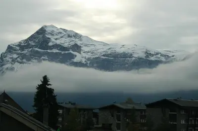 a snow covered mountain in the distance with houses and buildings at Les Carroz d'Araches in Les Carroz d'Araches