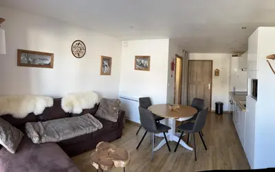 a living room with a couch and a table at Les Carroz d'Araches in Les Carroz d'Araches