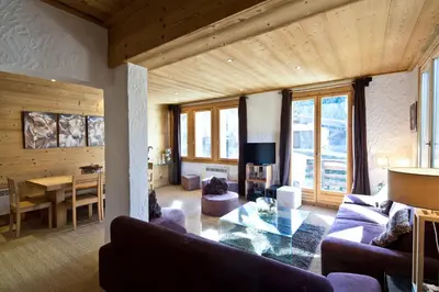 a living room with a couch and a table at Chalet la Brunette in Megève