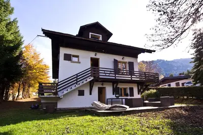 a white house with a balcony on the side of it at Chalet la Brunette in Megève
