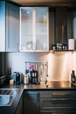 a kitchen with white cabinets and a counter top at Chalet la Brunette in Megève