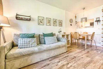 a living room with a couch and a table at Apartment Chamois Blanc 1 - Central Chamonix Haven in Chamonix-Mont-Blanc