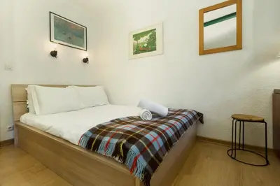 a bedroom with a bed with a blanket on it at Apartment Chamois Blanc 1 - Central Chamonix Haven in Chamonix-Mont-Blanc