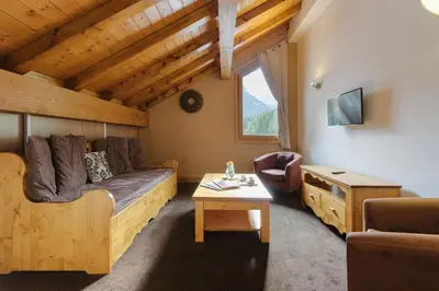 a living room with a couch and a table at Vallorcine Mont Blanc Spa in Vallorcine
