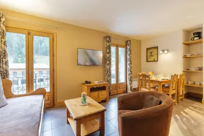 a living room with a couch and a table at Vallorcine Mont Blanc Spa in Vallorcine