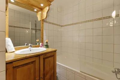 a bathroom with a sink and a bath tub at Vallorcine Mont Blanc Spa in Vallorcine