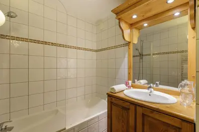 a bathroom with a sink and a bath tub at Vallorcine Mont Blanc Spa in Vallorcine