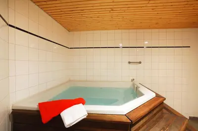 a bathroom with a bath tub with a red towel at Résidence Goélia Le Nevez in Les Contamines-Montjoie