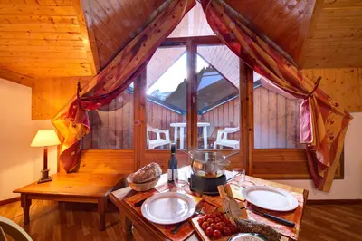 a room with a table in a cabin at Résidence Goélia Le Nevez in Les Contamines-Montjoie
