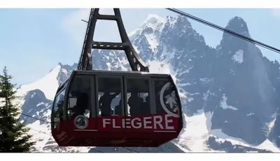 a ski lift in front of a snow covered mountain at Eden Hotel, Apartments and Chalet Chamonix Les Praz in Chamonix-Mont-Blanc