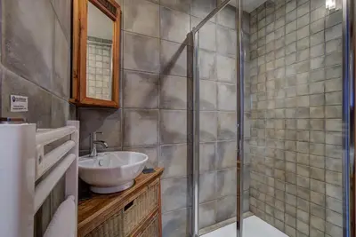 a bathroom with a sink and a shower at Chalet Capricorne in Chamonix-Mont-Blanc
