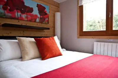 a bedroom with a bed with red and white pillows at Chalet Les Favrands in Chamonix-Mont-Blanc