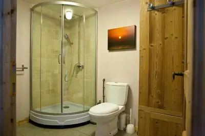 a bathroom with a toilet and a glass shower at Chalet Les Favrands in Chamonix-Mont-Blanc