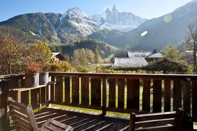 a wooden deck with a view of a mountain at Chalet Amelie in Chamonix-Mont-Blanc