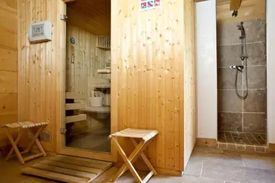a bathroom with a shower and two stools in it at Chalet Amelie in Chamonix-Mont-Blanc