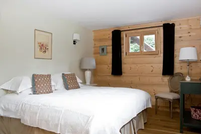 a bedroom with a white bed and a window at Chalet Amelie in Chamonix-Mont-Blanc