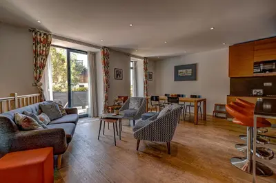 a living room with a couch and chairs and a table at Résidence Les Chamois in Chamonix-Mont-Blanc