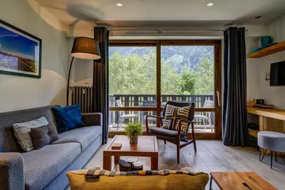 a living room with a couch and a table at Le Brevent 3 Apartment in Chamonix-Mont-Blanc