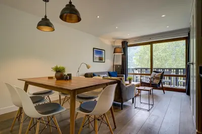 a living room with a wooden table and chairs at Le Brevent 3 Apartment in Chamonix-Mont-Blanc