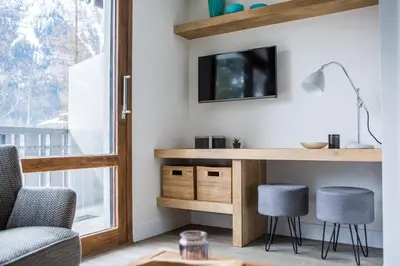 a home office with a desk and two stools at Le Brevent 3 Apartment in Chamonix-Mont-Blanc