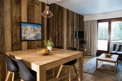 a dining room with a wooden table and chairs at Le Brevent 2 Apartment in Chamonix-Mont-Blanc