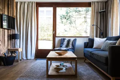 a living room with a couch and a table at Le Brevent 2 Apartment in Chamonix-Mont-Blanc