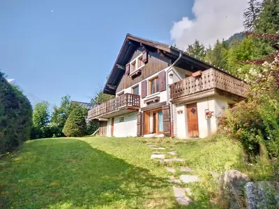 a house on a hill with a grass yard at MontBlanc Balcony Chamonix in Chamonix-Mont-Blanc