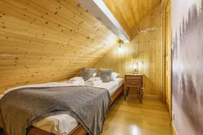 a bedroom with a bed in a wooden room at MontBlanc Balcony Chamonix in Chamonix-Mont-Blanc